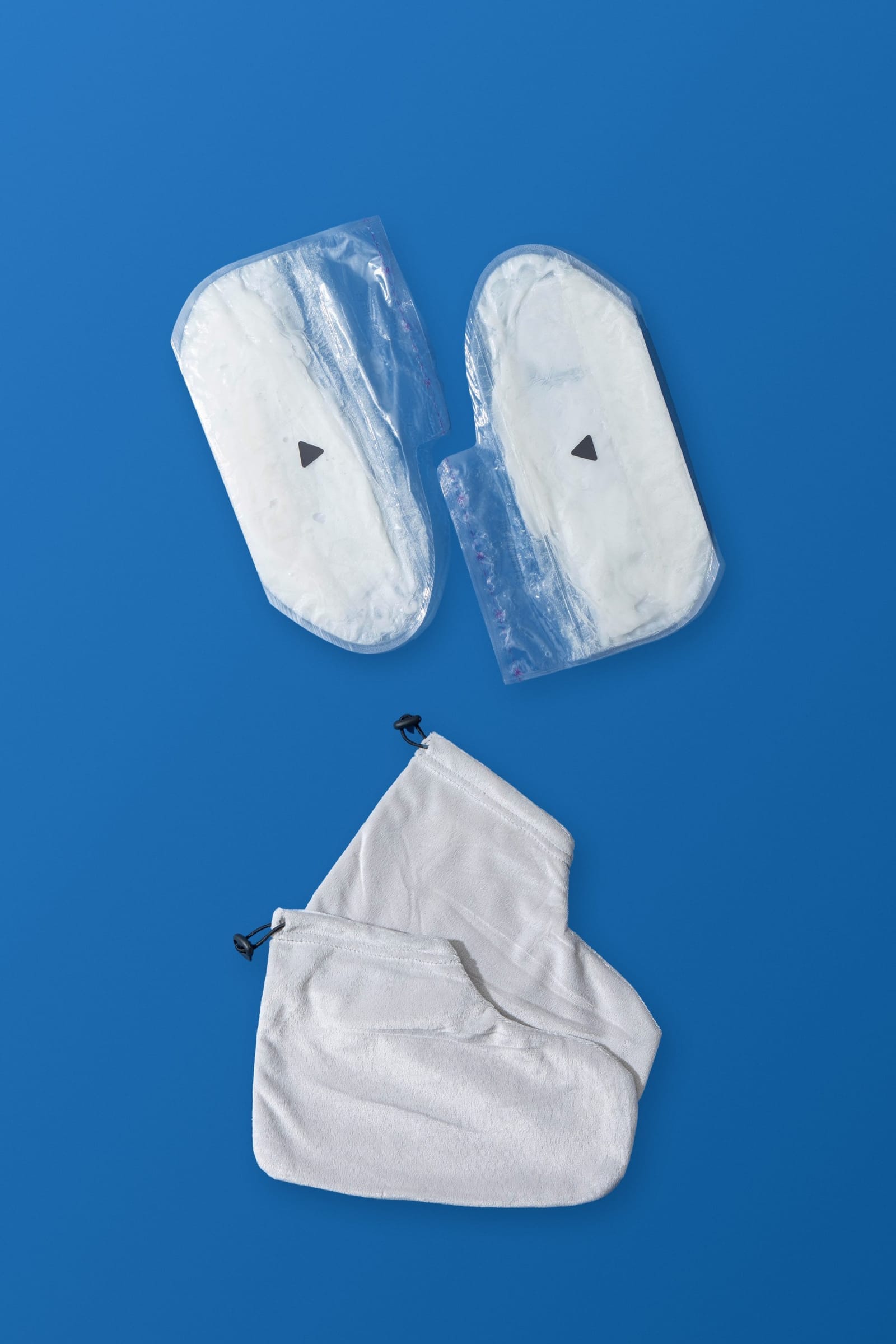 The Foot Ritual: a pair of paraffin beauty wax foot masks with their reusable terry cloth covers