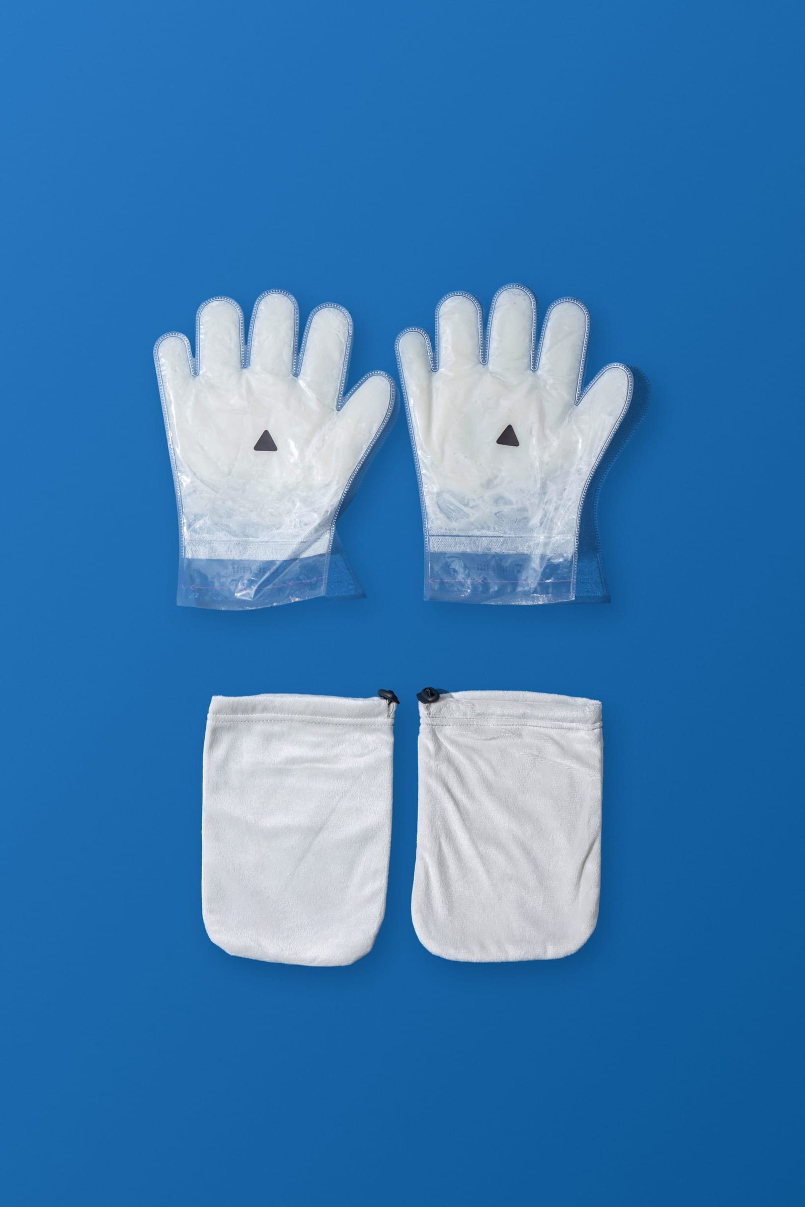 The Hand Ritual: a pair of paraffin beauty wax hand masks with their reusable terry cloth covers